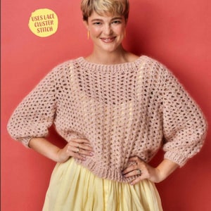 May include: A light pink, open-weave crochet sweater with three-quarter sleeves. The sweater is paired with a yellow skirt. Text on the image reads "USES LACE CLUSTER STITCH".