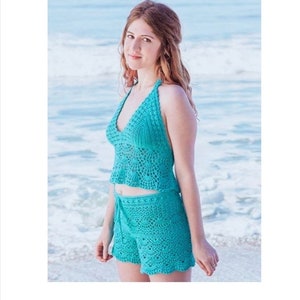 May include: A turquoise crochet halter top and shorts set. The top has a v-neck and the shorts have a drawstring waist.