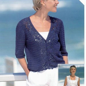 May include: A navy blue crochet cardigan with a V-neck and three-quarter sleeves. The cardigan features floral detailing and button closures. The word "CROCHET" is printed in white in the upper right corner. The model is wearing white pants.