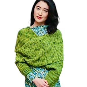 May include: A green knitted sweater with a v-neck and long sleeves. The sweater is made with a textured stitch and has a relaxed fit.