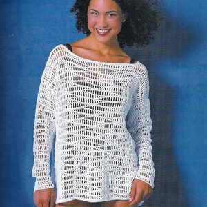 May include: A white crochet top with a loose fit and long sleeves. The top has a wide, open neckline and a delicate, open-weave pattern.