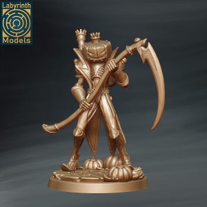 May include: A gold-colored miniature figurine of a pumpkin-headed figure holding a scythe. The figure is wearing a crown and a long, flowing robe. The figure is standing on a base with pumpkins.