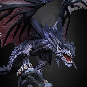 May include: A black dragon with red and black wings is perched on a grey rock. The dragon has sharp teeth and claws, and its eyes are red.