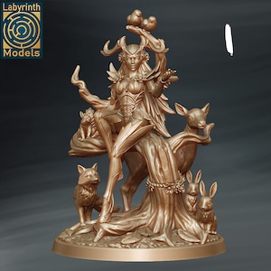 May include: A golden statue of a female figure with antlers, wings, and a flowing dress. She is surrounded by animals, including a deer, a fox, and two rabbits. The statue is set on a tree stump base.