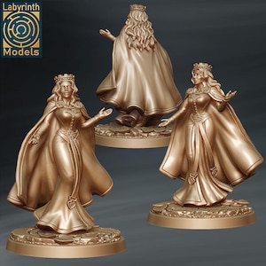 May include: Three gold-colored statues of a queen wearing a crown and flowing cape. The statues are in different poses, with one showing the back of the queen. The statues are on a circular base. The logo "Labyrinth Models" is in the upper left corner.