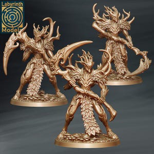 以下が含まれることがあります： 角と葉のディテールを持つヒューマノイドクリーチャーの金色のミニチュアフィギュア3体。各フィギュアは武器を持ち、円形のベースの上に立っています。