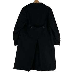 May include: A long, black coat with a classic design. The coat features a button closure, a notched collar, and a split back. The coat is hanging on a wooden hanger.