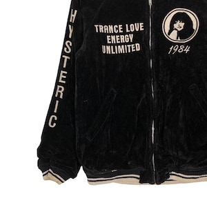 May include: Black velvet bomber jacket with white lettering that reads "HYSTERIC" on the left sleeve and "TRANCE LOVE ENERGY UNLIMITED 1984" on the front.