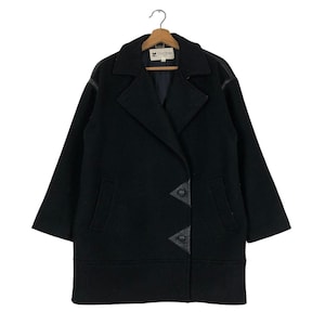 May include: A black wool coat with a double-breasted design, featuring leather accents on the lapels and front closure. The coat has a classic collar, two front pockets, and is hanging on a wooden hanger.