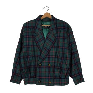 May include: A green, red, and black plaid double-breasted jacket with a  "A.S.U" label.
