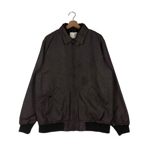 May include: A dark charcoal gray zip-up jacket featuring a classic collar, long sleeves with black ribbed cuffs, and a matching black ribbed hem. The garment includes two front pockets with button closures and a central full-length zipper closure.