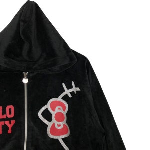 May include: Black velour hooded sweatshirt with a red and silver Hello Kitty graphic on the front. The graphic features Hello Kitty's signature bow and whiskers.