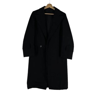 May include: A long, black overcoat with a classic design. The coat features a notched lapel, a single-button closure, and long sleeves with cuff details. It is hanging on a wooden hanger against a white background.