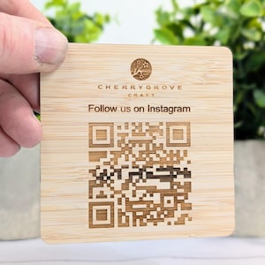 May include: A wooden coaster with a laser-engraved QR code and the text "Cherry Grove Craft Follow us on Instagram".