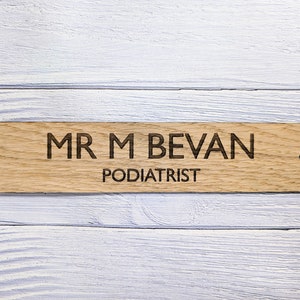May include: A wooden sign with the text "MR M BEVAN PODIATRIST" engraved on it.