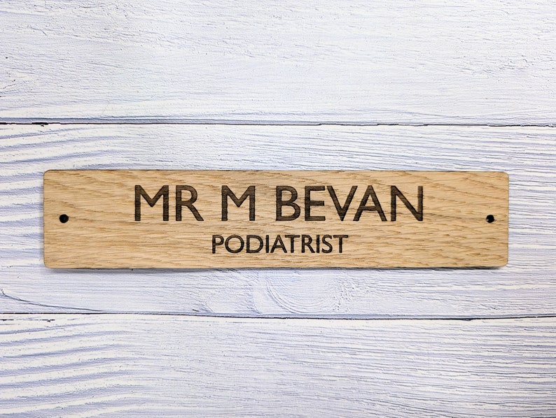 May include: A wooden sign with the text "MR M BEVAN PODIATRIST" engraved on it.