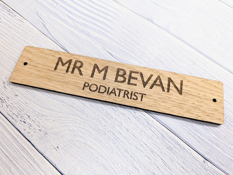 May include: A wooden sign with the text "MR M BEVAN PODIATRIST" engraved on it.