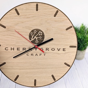 May include: A wooden clock with black hands and a red second hand. The clock face has a cherry blossom design and the text "CHERRY GROVE CRAFT".