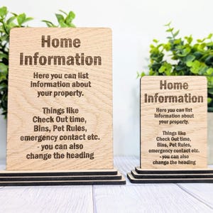 May include: Two wooden signs with the text "Home Information" and instructions on how to list information about a property. The signs are on a wooden stand.