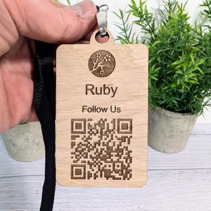 May include: A wooden keychain with a QR code, the text "Ruby Follow Us", and a small tree design.