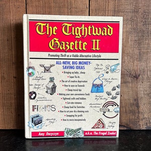 May include: The cover of a book titled "The Tightwad Gazette II: Promoting Thrift as a Viable Alternative Lifestyle". The cover features illustrations of a moose, a house, a pizza, and a purse. The book is written by Amy Dacyczyn, a.k.a. The Frugal Zealot.
