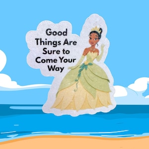May include: A sticker featuring a cartoon princess in a green and yellow gown, with the text "Good Things Are Sure to Come Your Way." The background shows a beach scene with blue sky and water.