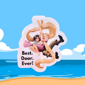 May include: A sticker featuring a cartoon illustration of a couple with long blonde hair, hanging from the hair. The text "Best. Door. Ever!" is printed on the sticker. The background shows a beach and blue sky.