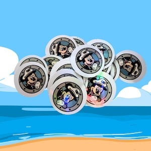 May include: A collection of round, white stickers featuring Mickey Mouse in a sailor's hat and uniform. The stickers have a silver border and a holographic effect. The background is a cartoon beach scene with blue sky and ocean.