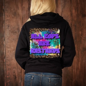 May include: Black hooded sweatshirt with a colourful tie-dye design and leopard print background. The text "ALL COPS ARE BASTARDS" is printed in purple on the back of the sweatshirt.