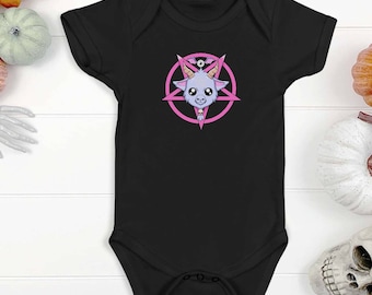 May include: Black baby growsuit featuring a pink pentagram with a cartoon goat inside. The goat has a pink halo and collar, large eyes and a pink nose.