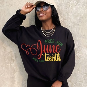 May include: Black sweatshirt with a red, yellow and green graphic that says "Free-ish Juneteenth Since 1865".