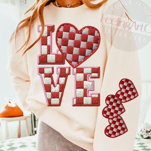 May include: Cream-colored sweatshirt with the word "LOVE" in red and white checkered pattern. A large heart with the same pattern is above the "VE". Three checkered hearts are on the sleeve. The text "FeelingArtCo Do not copy" is on the upper right.