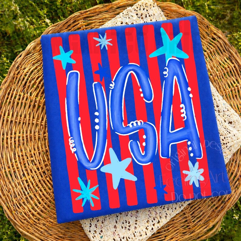 May include: A patriotic design featuring the word "USA" in blue, adorned with stars, set against a red and blue striped background. The design is on a blue rectangular surface.