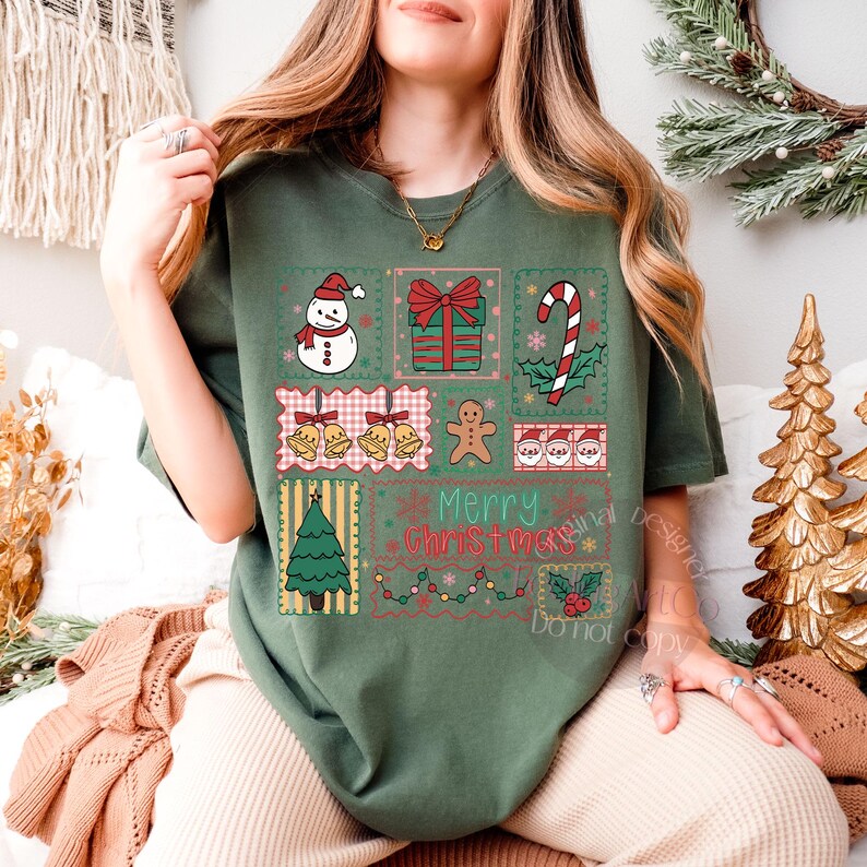 May include: Green t-shirt featuring a patchwork design with Christmas-themed illustrations. The design includes a snowman, gift, candy cane, bells, gingerbread man, Santa faces, Christmas tree, and the text "Merry Christmas".
