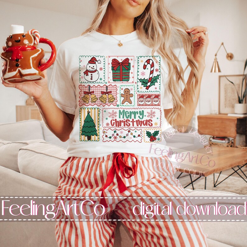May include: White t-shirt with a colorful Christmas-themed graphic. The design includes a snowman, gift, candy cane, bells, gingerbread man, tree, and the words "Merry Christmas." The person is wearing red and white striped pajama pants.