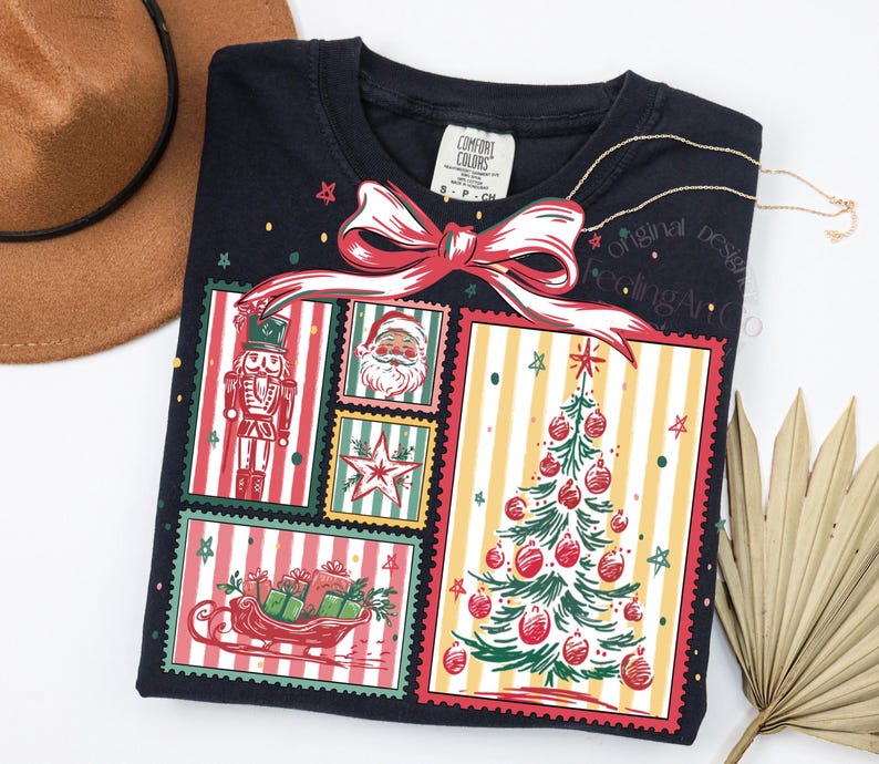 May include: A navy blue sweatshirt features a festive Christmas design. The graphic includes a nutcracker, Santa Claus, a star, a sleigh with gifts, and a Christmas tree. A red bow tops the design. The shirt has the words "Original Feeling Art" on it.