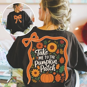 May include: A white ceramic mug with a black handle and the text "But First, Coffee" in a bold, black font. The mug is filled with a dark liquid, likely coffee, and sits on a light-colored surface.