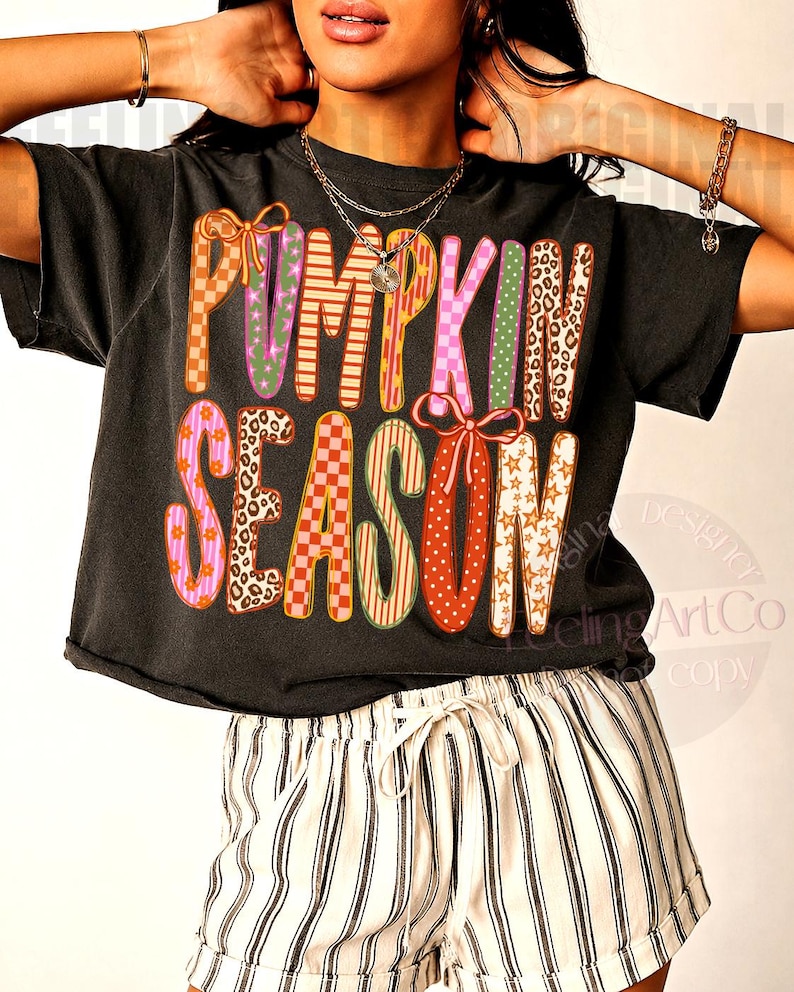 May include: A black short-sleeved t-shirt featuring the text PUMPKIN SEASON in large, multi-colored letters with various patterns including leopard print, checkers, stars, and stripes, paired with white and black vertical striped shorts.