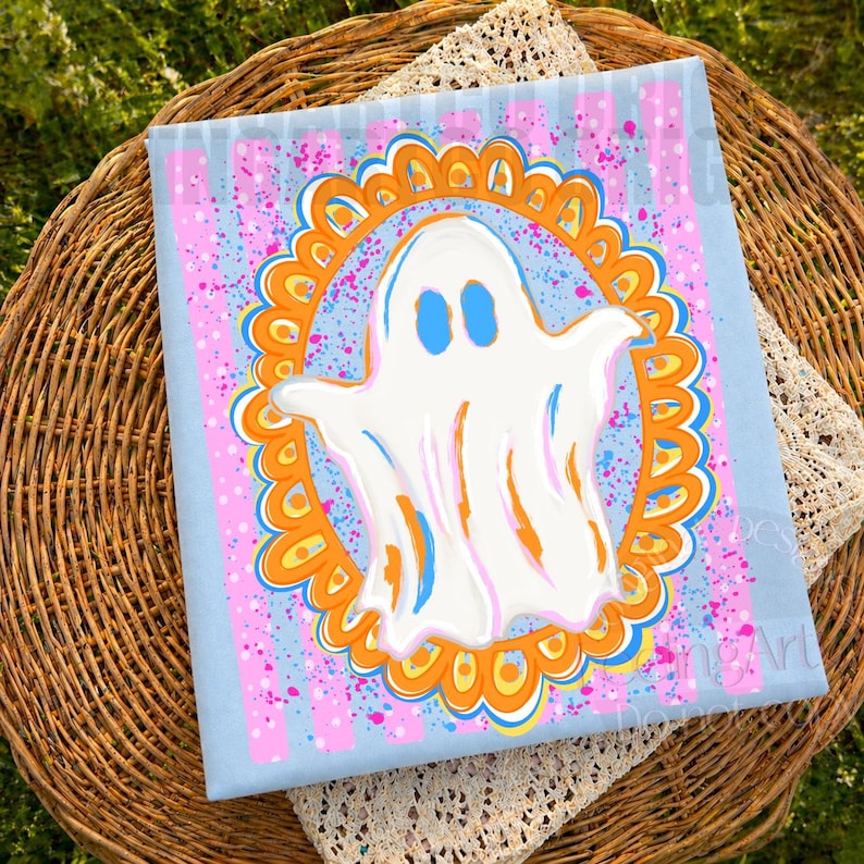 May include: A square canvas print featuring a central white ghost with blue eyes, enclosed within an orange and yellow scalloped oval frame. The background consists of light blue vertical stripes with pink and blue paint splatter accents.