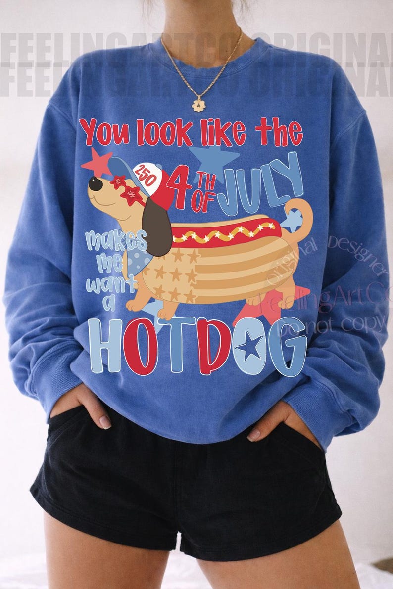 May include: Blue sweatshirt with a graphic of a hotdog dog wearing sunglasses and a hat, with the text "You look like the 4th of July" and "Hotdog". The design includes stars and the text "makes me want a".