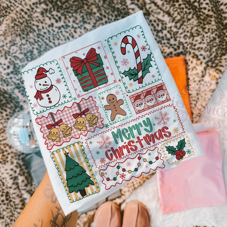 May include: A white Christmas-themed tea towel featuring various festive illustrations. Designs include a snowman, gift, candy cane, gingerbread man, Santa faces, bells, Christmas tree, and the text "Merry Christmas". The towel is decorated with snowflakes and holly.
