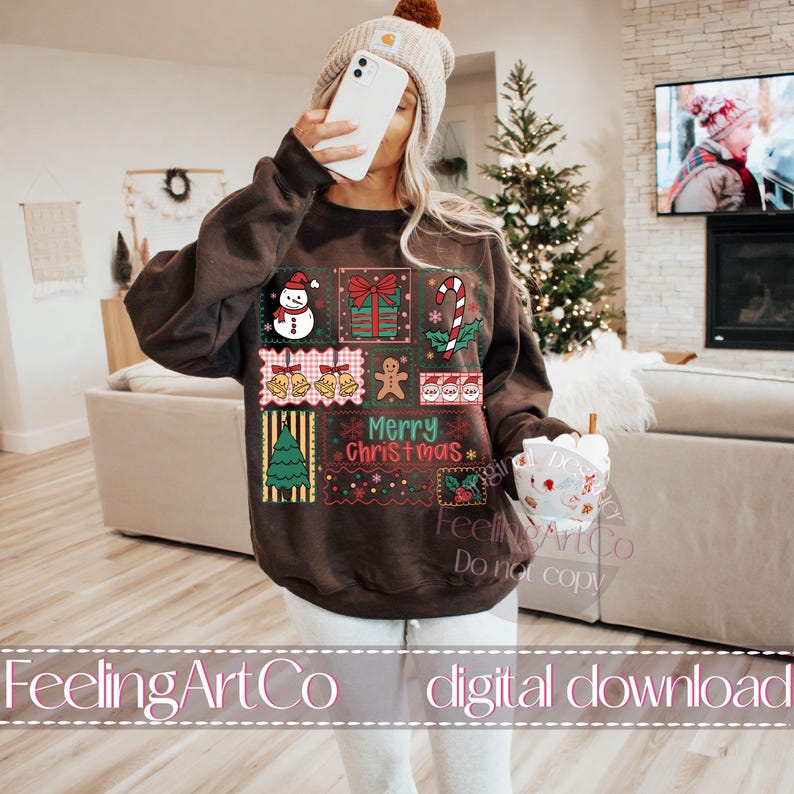 May include: A brown sweatshirt with a festive Christmas design. The design includes a snowman, wrapped gifts, candy cane, bells, gingerbread man, and a Christmas tree. The words "Merry Christmas" are also featured.
