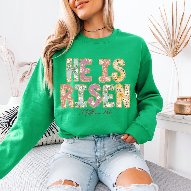May include: Green sweatshirt with a floral design that says "He is Risen" and "Matthew 28:6".