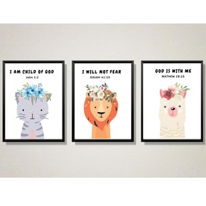 May include: Three framed prints with inspirational quotes and cute animal illustrations. The first print features a gray cat with a flower crown and the quote "I am child of God, John 1:2". The second print features a lion with a flower crown and the quote "I will not fear, Isaiah 41:10". The third print features a llama with a flower crown and the quote "God is with me, Mathew 28:20".