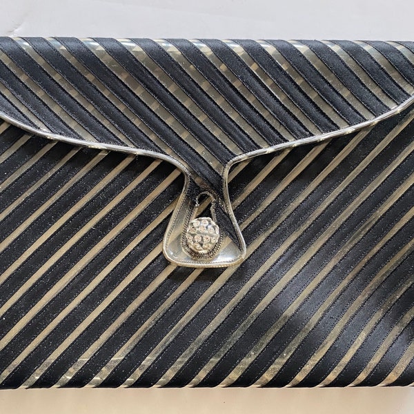 Vintage clear plastic clutch embroidered with black ribbons. 1960