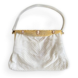 Vintage Eugène Élias evening bag embroidered with white pearls and openwork and engraved gold flap. 3 cameos on the front. 1930