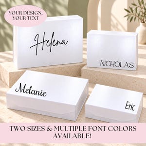 May include: Four rectangular white gift boxes of varying sizes, each featuring custom black text on the front. The boxes are arranged in two pairs, displaying the names Helena, Nicholas, Melanie, and Eric in different black font styles.