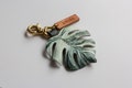 Monstera Deliciosa var Borsigiana 'Albo' Variegated Leather Bag Charm, Swiss Cheese Plant Key Chain, Bag Accessories with Shiny Brass Clasp product logo