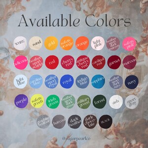 May include: A chart of available colours for clothing, with colour swatches in circles. The colours include white, sand, gold, safety orange, orange, light pink, heather sport dark maroon, safety pink, heliconia, heather sport scarlet, red, cherry red, antique cherry red, cardinal red, garnet, maroon, light blue, carolina blue, heather sport royal, royal, indigo blue, sapphire, heather sport dark navy, navy, purple, safety green, irish green, heather sport dark green, military green, forest, ash, sport grey, graphite heather, charcoal, dark heather, dark chocolate, black.