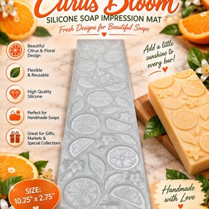 May include: A rectangular gray silicone soap impression mat featuring an embossed pattern of citrus slices, leaves, and blossoms. The mat measures 10.25 inches by 2.75 inches. It is displayed alongside a finished rectangular soap bar with the same design.